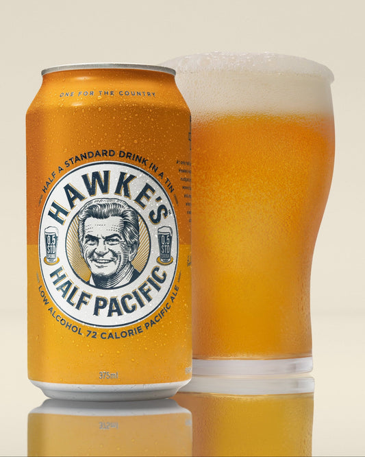 Hawke's Half Pacifier beer can and glass on a beige background